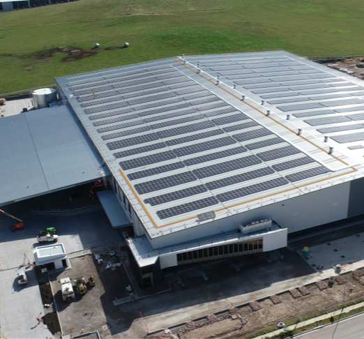 Aerial view of rooftop solar panels on a warehouse